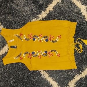 Mustard yellow tank with floral detail and tie at waist